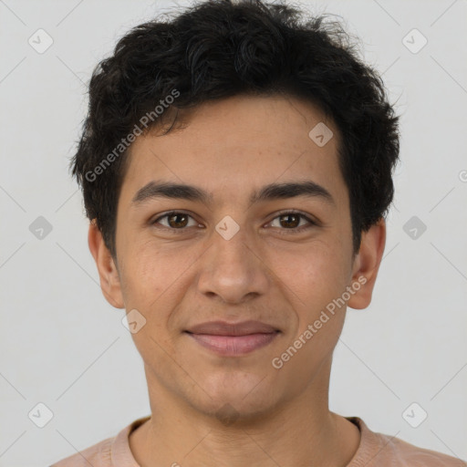 Joyful latino young-adult male with short  brown hair and brown eyes