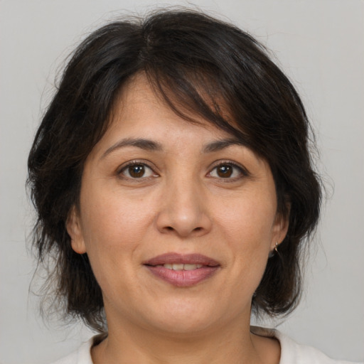 Joyful white adult female with medium  brown hair and brown eyes