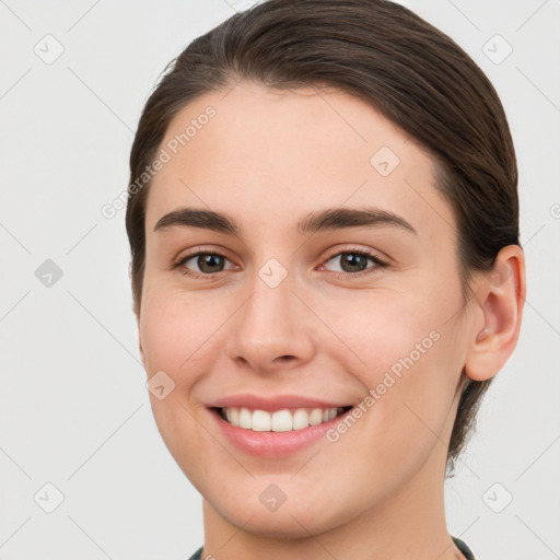 Joyful white young-adult female with short  brown hair and grey eyes