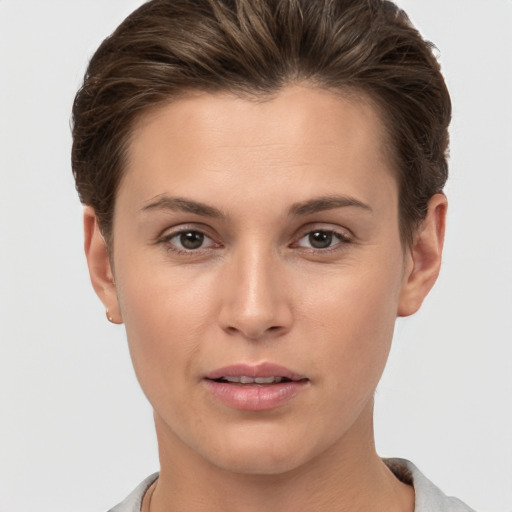 Joyful white young-adult female with short  brown hair and brown eyes