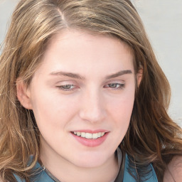 Joyful white young-adult female with long  brown hair and blue eyes