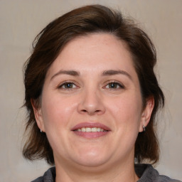 Joyful white adult female with medium  brown hair and brown eyes