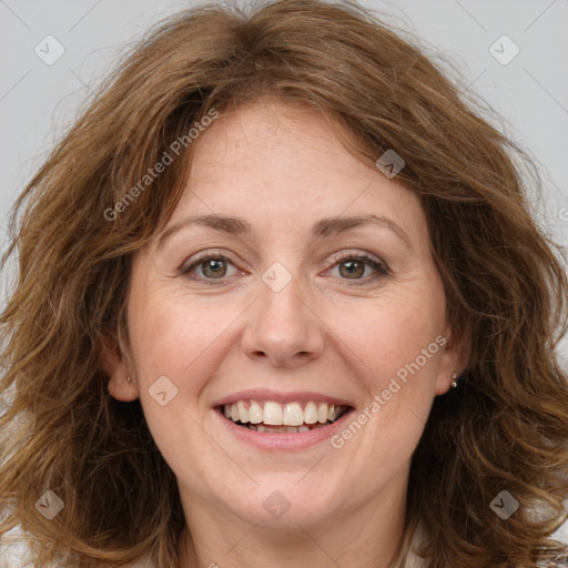 Joyful white adult female with long  brown hair and brown eyes