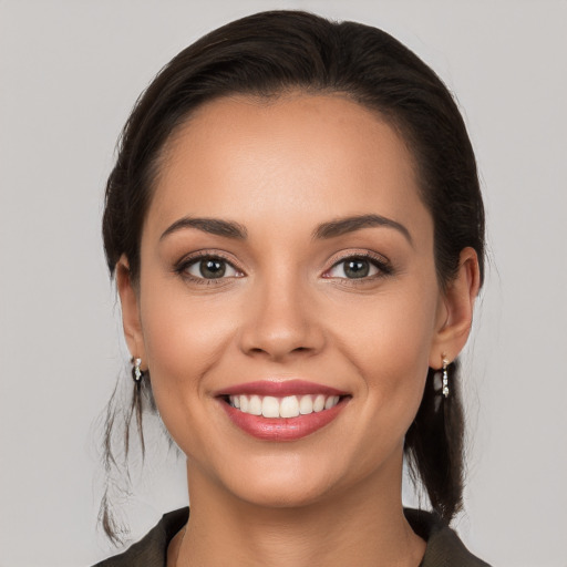 Joyful white young-adult female with long  brown hair and brown eyes