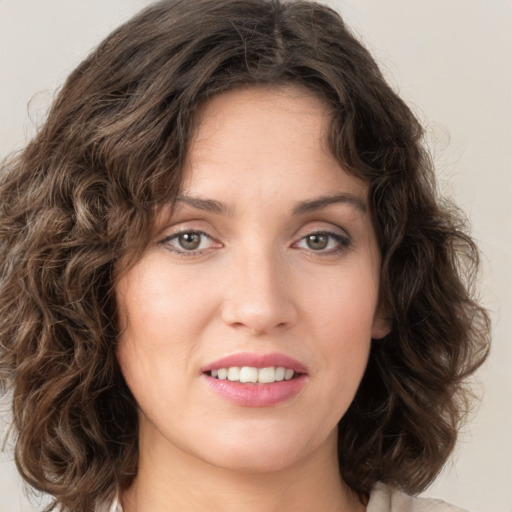 Joyful white young-adult female with medium  brown hair and green eyes