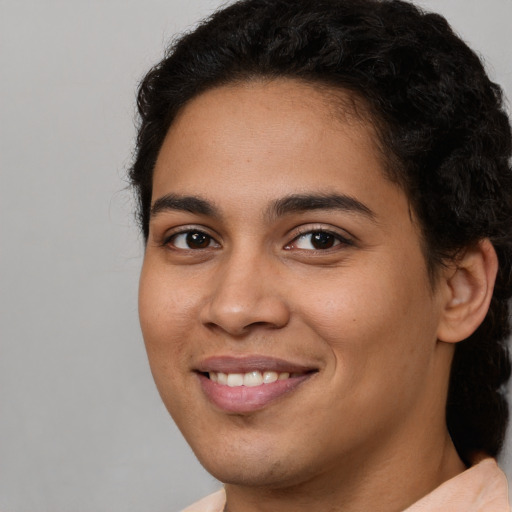 Joyful latino young-adult female with short  brown hair and brown eyes