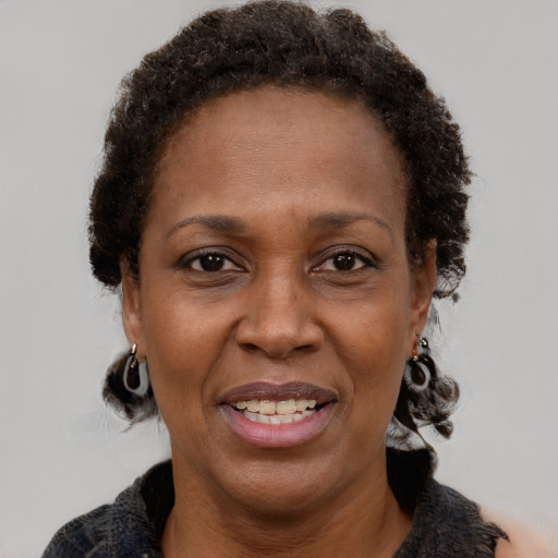 Joyful black adult female with short  brown hair and brown eyes