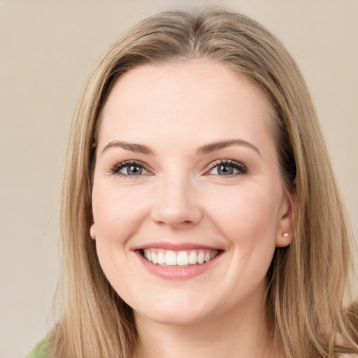 Joyful white young-adult female with long  brown hair and green eyes