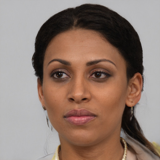 Joyful black young-adult female with medium  brown hair and brown eyes