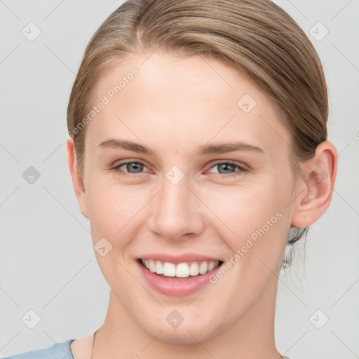 Joyful white young-adult female with medium  brown hair and blue eyes