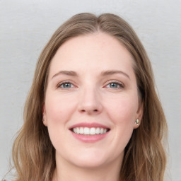 Joyful white young-adult female with long  brown hair and grey eyes