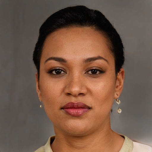 Joyful latino young-adult female with short  black hair and brown eyes