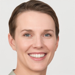 Joyful white young-adult female with short  brown hair and grey eyes