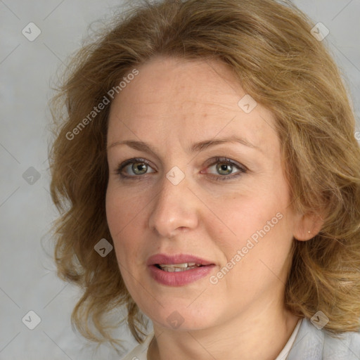 Joyful white adult female with medium  brown hair and blue eyes