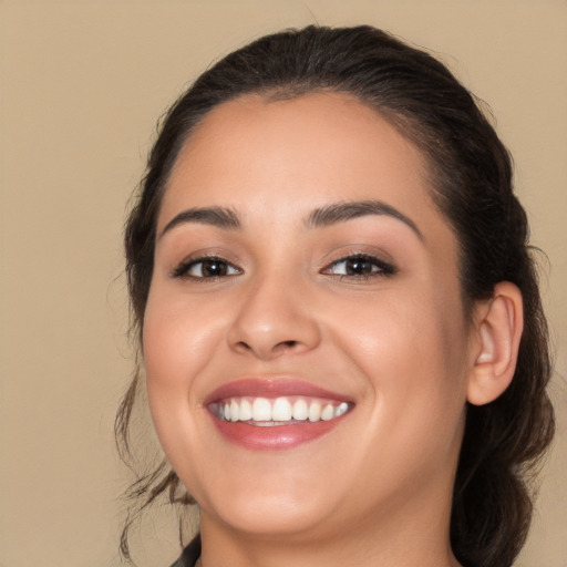 Joyful white young-adult female with long  brown hair and brown eyes