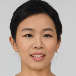 Joyful asian young-adult female with medium  black hair and brown eyes