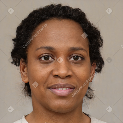 Joyful black adult female with short  brown hair and brown eyes