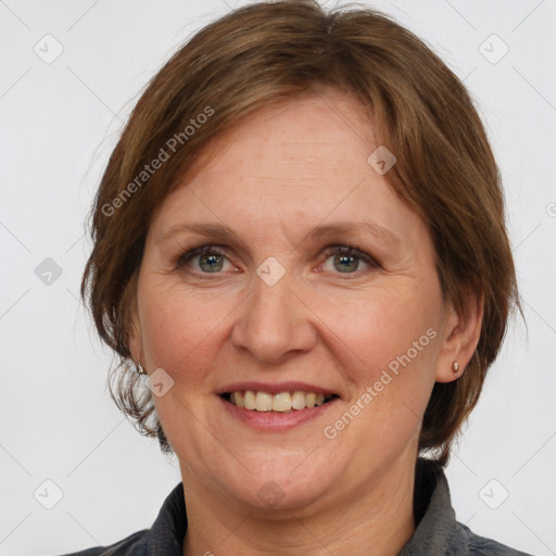 Joyful white adult female with medium  brown hair and grey eyes