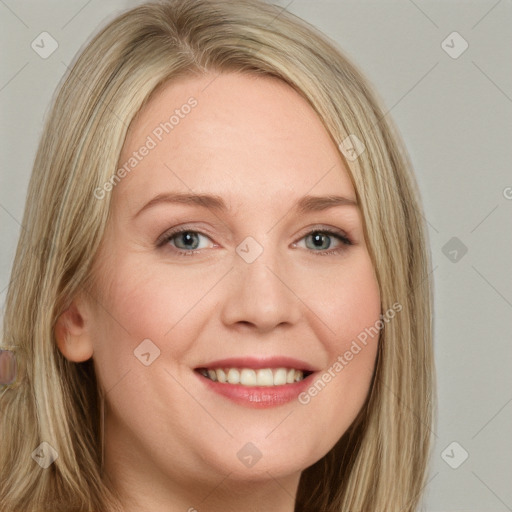 Joyful white young-adult female with long  brown hair and blue eyes