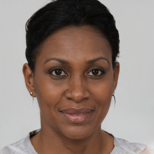 Joyful black adult female with short  black hair and brown eyes