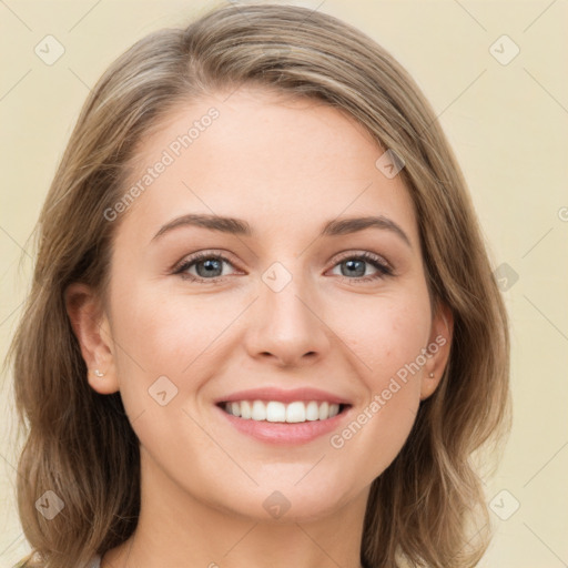 Joyful white young-adult female with long  brown hair and green eyes