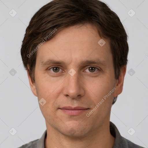 Joyful white adult male with short  brown hair and grey eyes