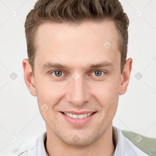 Joyful white young-adult male with short  brown hair and grey eyes