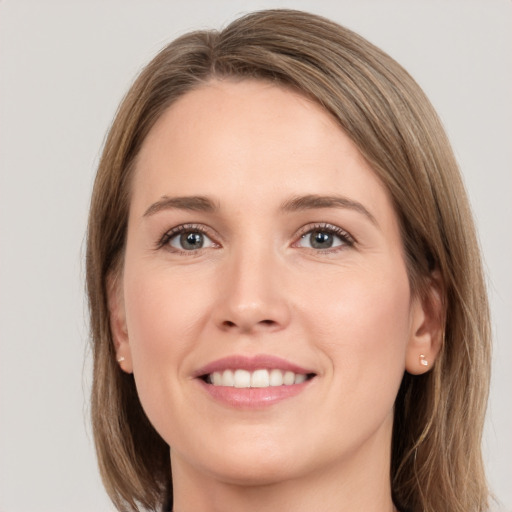 Joyful white young-adult female with medium  brown hair and grey eyes