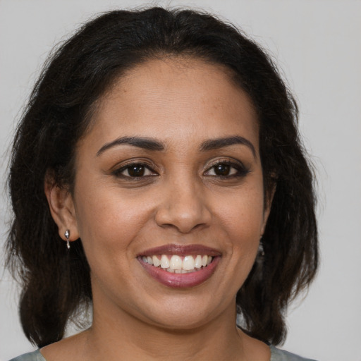 Joyful black young-adult female with medium  brown hair and brown eyes