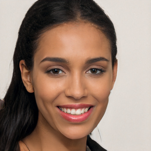 Joyful latino young-adult female with long  brown hair and brown eyes