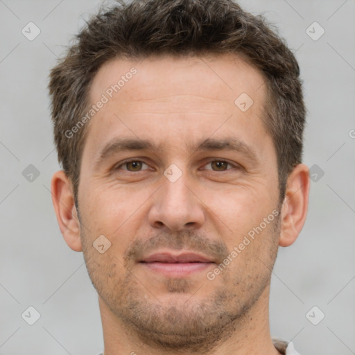 Joyful white adult male with short  brown hair and brown eyes