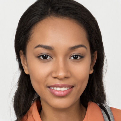 Joyful latino young-adult female with long  brown hair and brown eyes