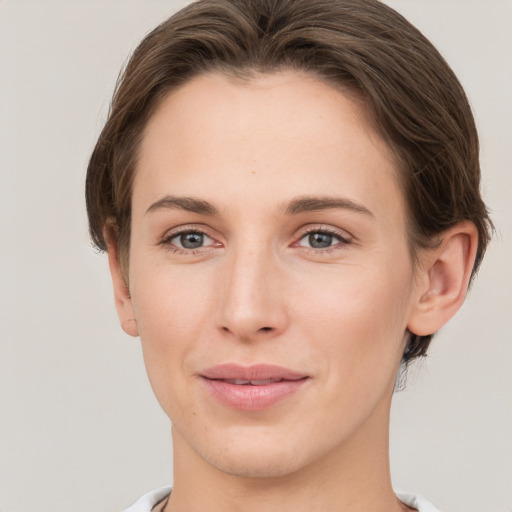 Joyful white young-adult female with short  brown hair and grey eyes