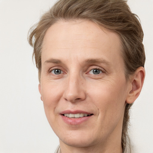 Joyful white adult female with short  brown hair and grey eyes