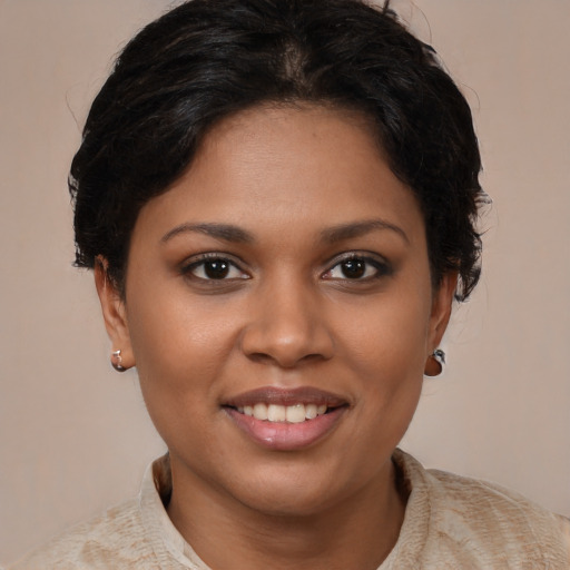 Joyful black young-adult female with medium  brown hair and brown eyes