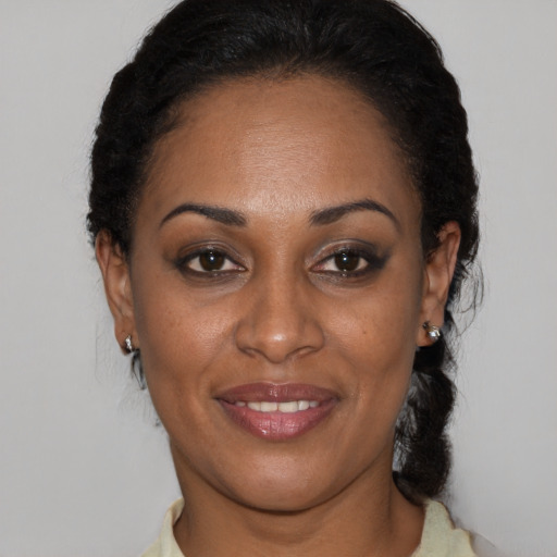 Joyful black adult female with short  black hair and brown eyes