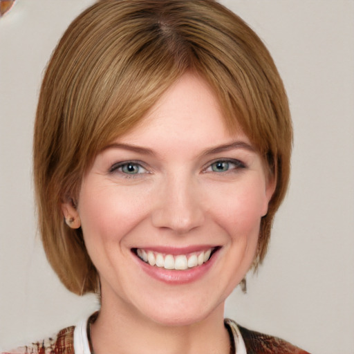 Joyful white young-adult female with medium  brown hair and blue eyes