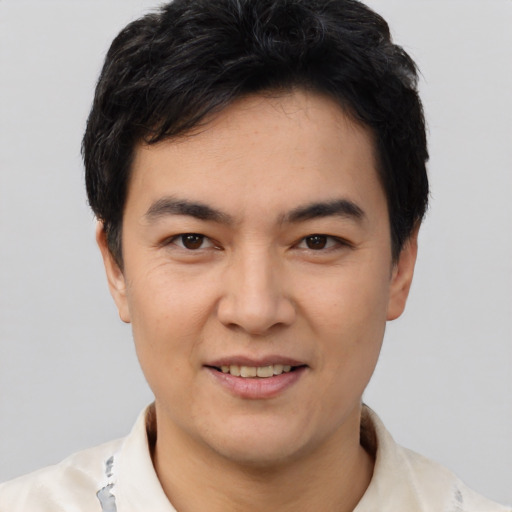 Joyful white young-adult male with short  black hair and brown eyes