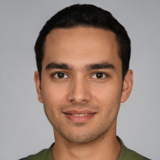 Joyful white young-adult male with short  black hair and brown eyes