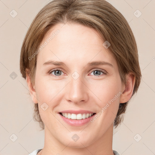 Joyful white young-adult female with medium  brown hair and green eyes