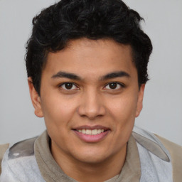 Joyful asian young-adult male with short  brown hair and brown eyes
