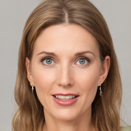 Joyful white young-adult female with medium  brown hair and green eyes