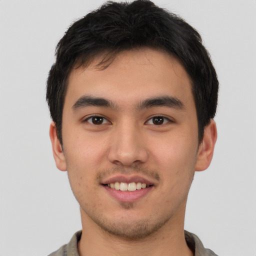 Joyful asian young-adult male with short  brown hair and brown eyes