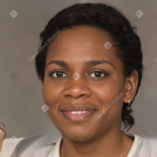 Joyful black young-adult female with short  black hair and brown eyes