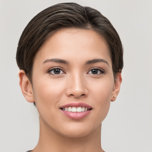 Joyful white young-adult female with short  brown hair and brown eyes