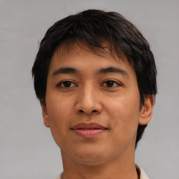 Joyful asian young-adult male with short  brown hair and brown eyes