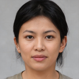 Joyful asian young-adult female with medium  brown hair and brown eyes