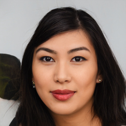 Joyful asian young-adult female with long  black hair and brown eyes