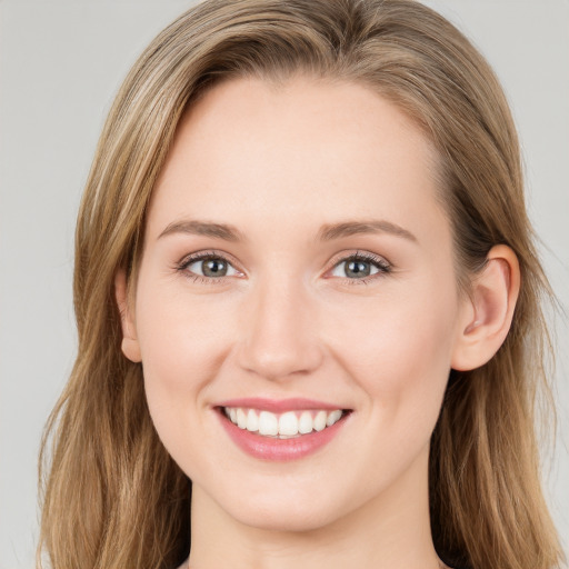 Joyful white young-adult female with long  brown hair and green eyes