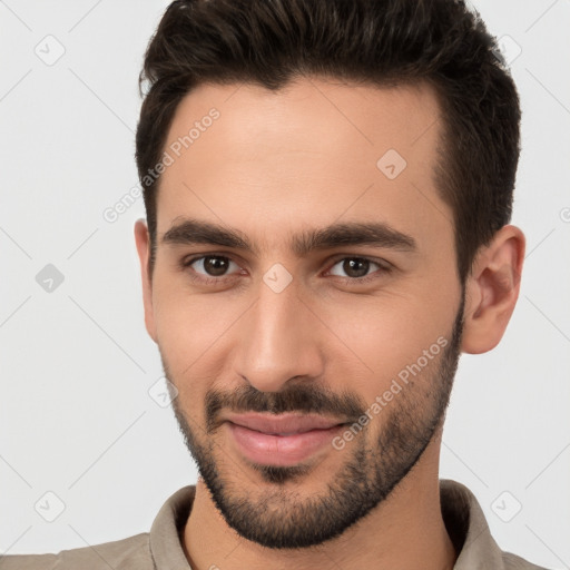 Joyful white young-adult male with short  brown hair and brown eyes